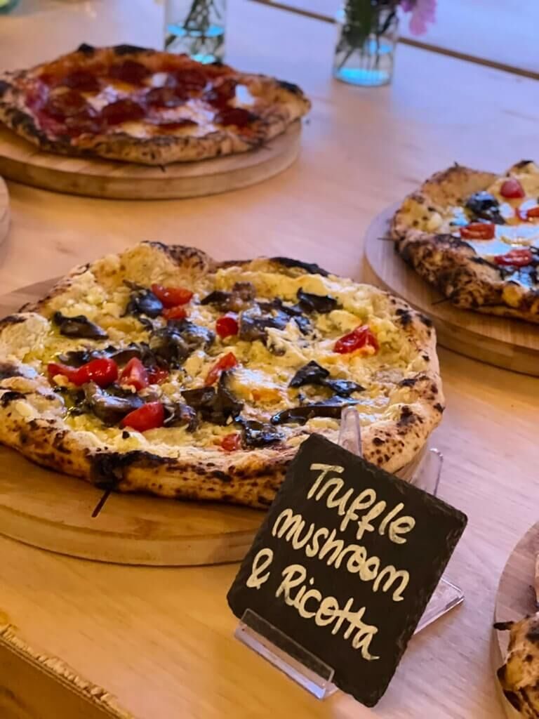 Roasted garlic and mushroom pizza with truffle ricotta, with a chalkboard label