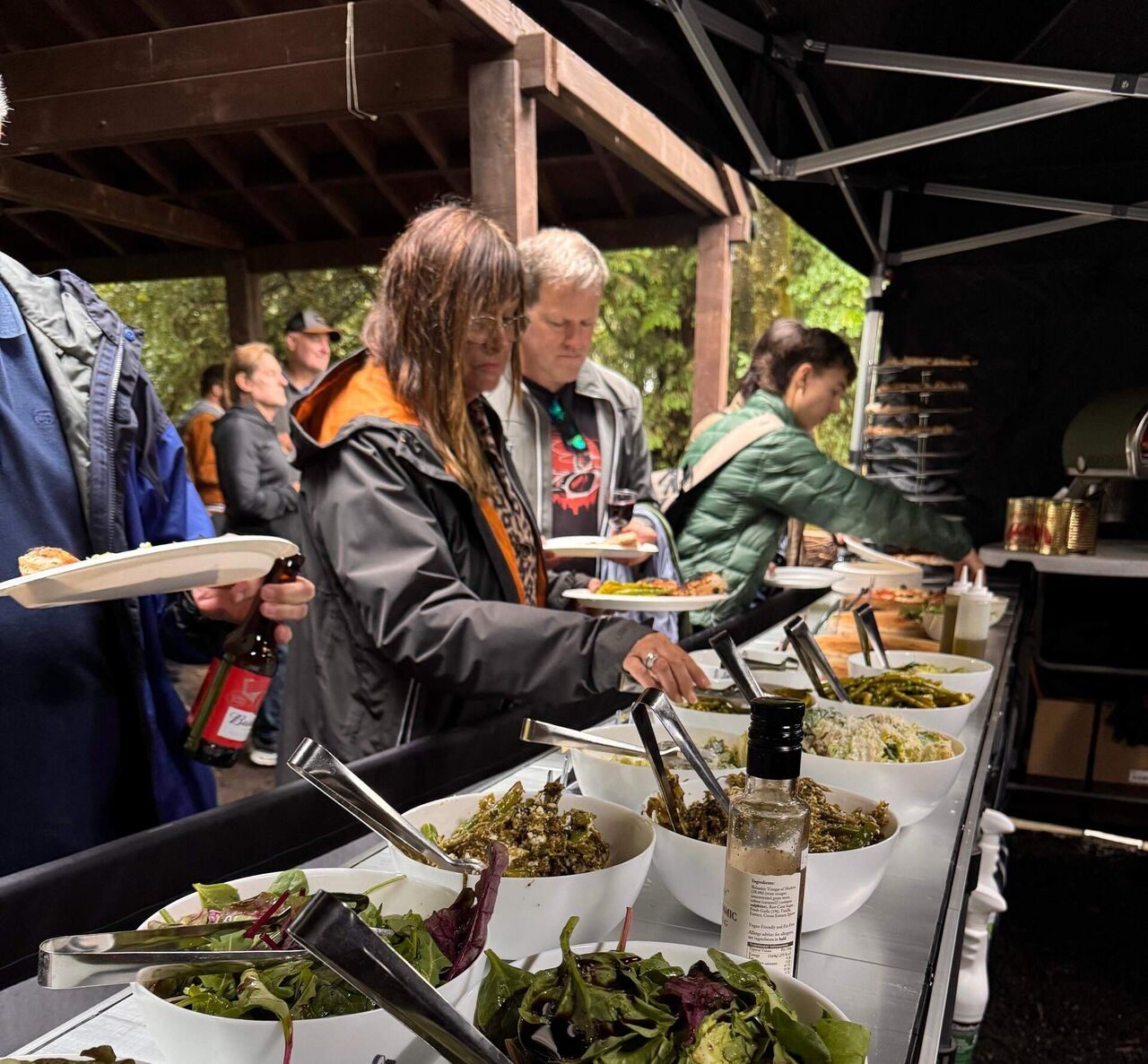 Guests serving themselves from the sides and salads buffet